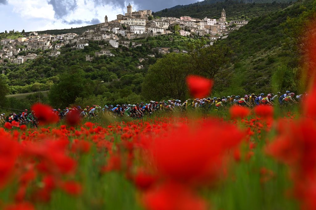 GRAN SASSO DITALIA CAMPO IMPERATORE ITALY MAY 12 A general view of the peloton passing close to Calascio Village 1190m during the 106th Giro dItalia 2023 Stage 7 a 218km stage from Capua to Gran Sasso dItalia Campo Imperatore 2123m UCIWT on May 12 2023 in Gran Sasso dItalia Campo Imperatore Italy Photo by Tim de WaeleGetty Images