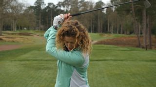 A golfer with a collapsed left elbow at the top of their backswing