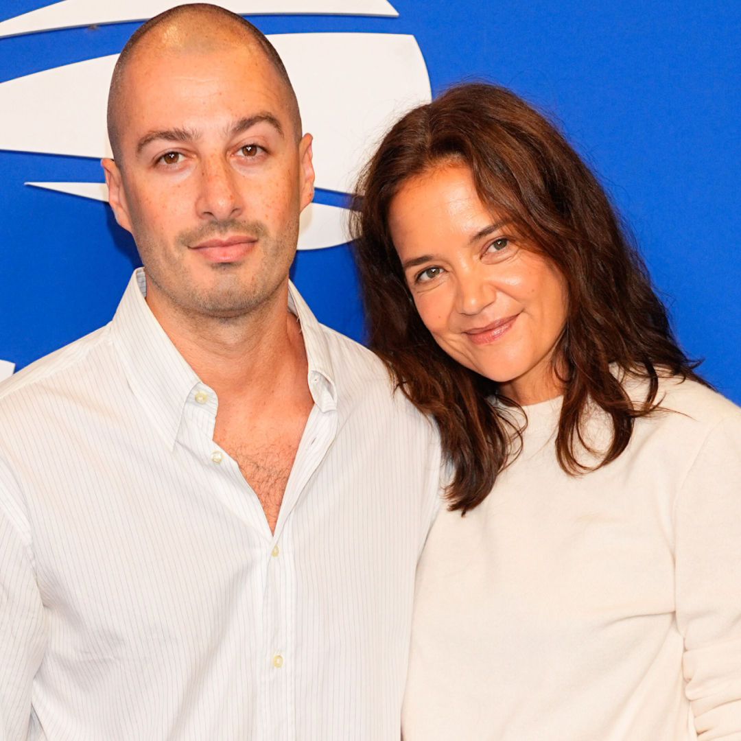 Katie Holmes wore a white crewneck sweater, black trousers, and leather loafers at the 2026 US Open