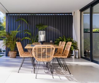 small patio with dining furniture and plants