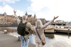 Beautiful senior citizen couple enjoying a beautiful day travelling together in Amsterdam