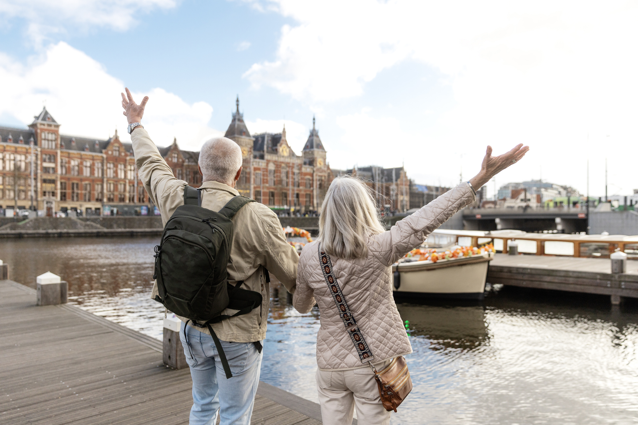 Beautiful senior citizen couple enjoying a beautiful day travelling together in Amsterdam