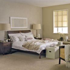 bedroom with golden colour wall and bed lamp