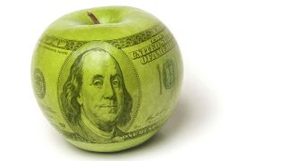 Green apple with superimposed $100 bill