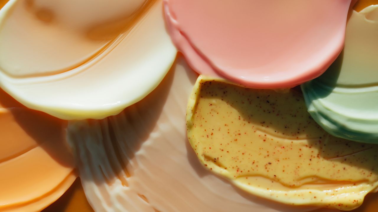 a selection of skincare creams layered on a backdrop