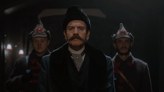 Ewan McGregor as the fictional Count Alexander Ilyich Rostov with a luxuriant mustache and looking unhappy as he is flanked on both sides by Russian soldiers 