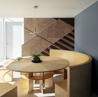 cork staircase with banquette dining seating area