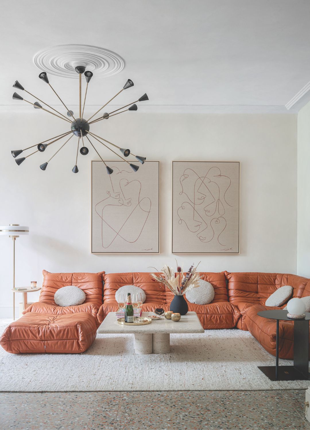 picture of a living room with a high ceiling and warm-toned furnishings