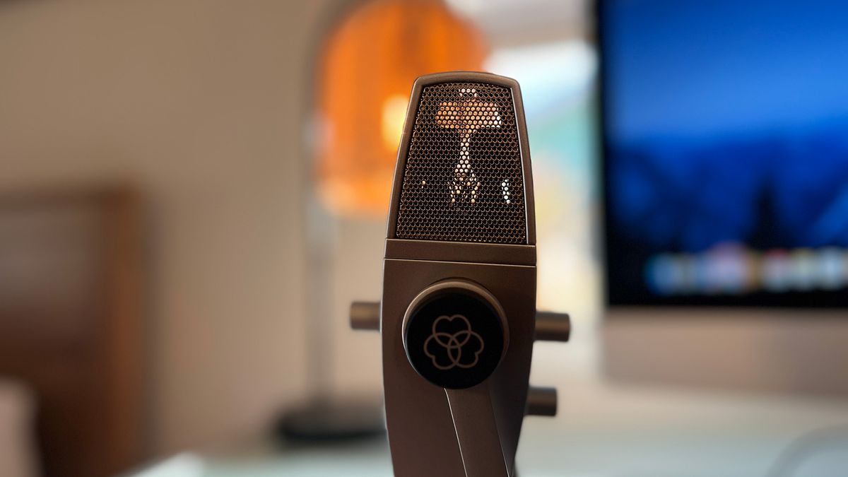 An AKG Lyra on a desk in front of an iMac