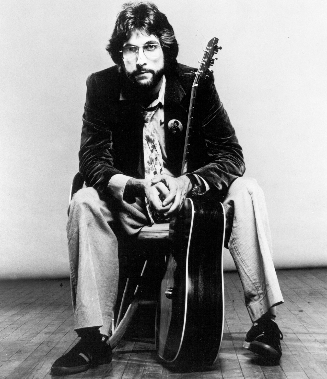 Stephen Bishop, seated with his guitar