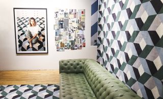 Green leather sofa surrounded by geometric rug