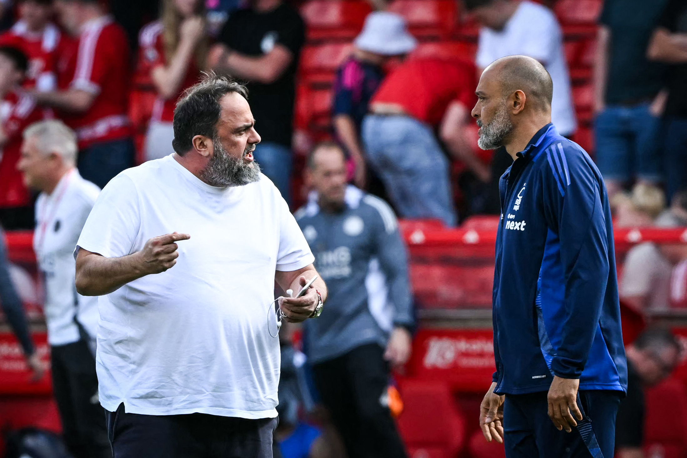 Evangelos Marinakis and Nuno Espirito Santa have a spirited discussion on the pitch at the City Ground