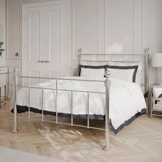 metal bed frame with white bedding on top