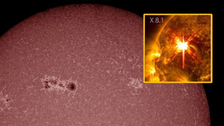 A view of a giant sunspot region in red, with a box showing a massive bright solar flare