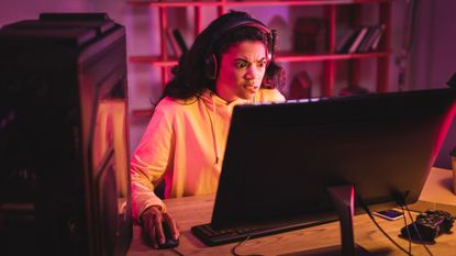 PC gamer looking confused at monitor