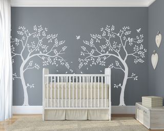 Gender neutral nursery ideas: Grey and white bedroom with white tree stencil by The Stencil Studio