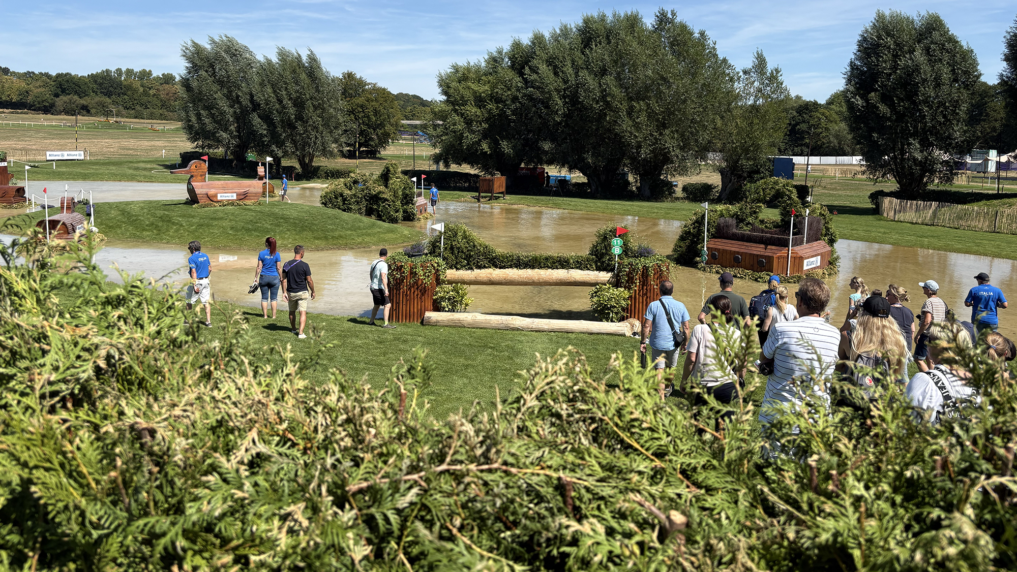 A view over a brush fence down to a water complex on the eventing World Championships cross-country course