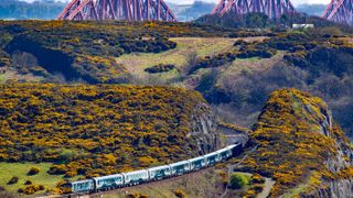 The Caledonian Sleeper train travelling over Forth Bridge
