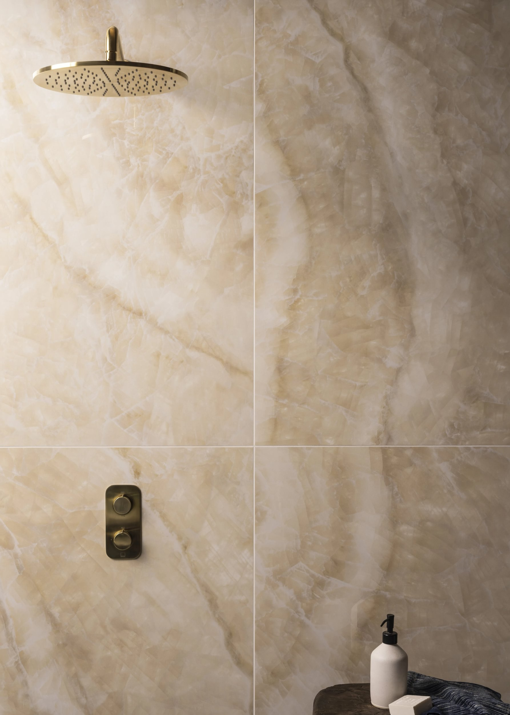 onyx-look tiles in a shower enclosure with a side table and body wash on the table