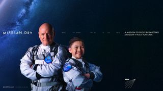 a man and a boy, each dressed in spacesuits, pose wearing mission patches against a dark background
