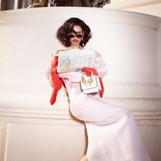 nara smith in Khaite dress and earrings; Rochas gloves; Roberto Cavalli bag; Cartier sunglasses; Bulgari bracelets; Dolce & Gabbana shoes