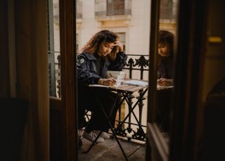 adobe certification: Young woman studying on her balony