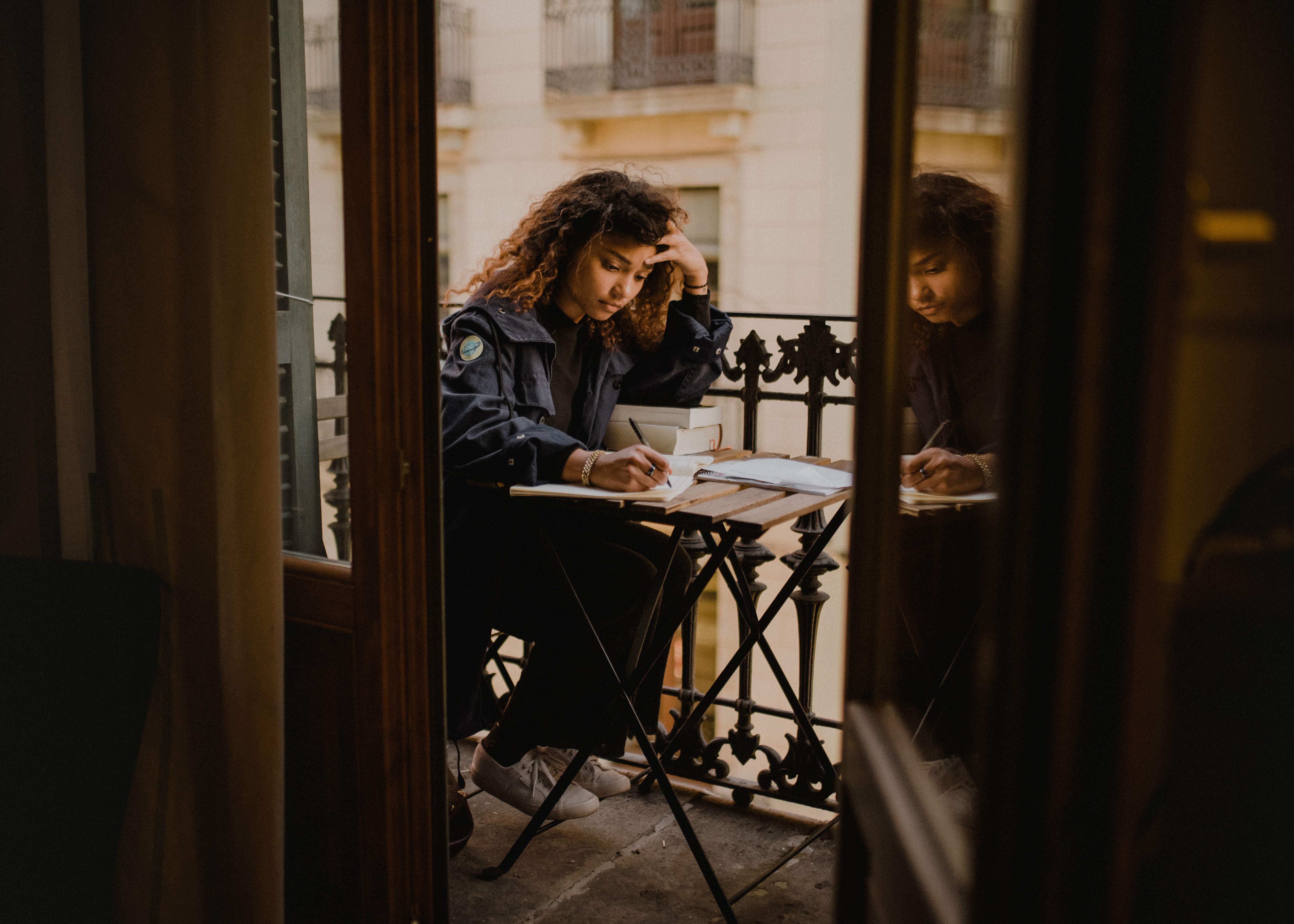 adobe certification: Young woman studying on her balony