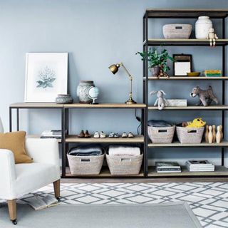 Living room shelving ideas with blue wall and black shelf units