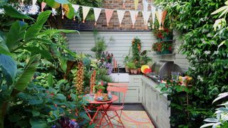 small courtyard garden with outdoor kitchen and patio furniture