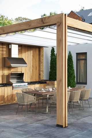 an outdoor kitchen under a retractable canopy