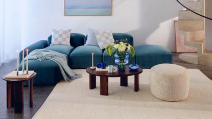 Blue home decor H&M home new blue collections living room with blue sofa and vase with cream rug 