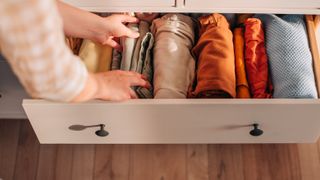 picture of woman opening drawer of clothes