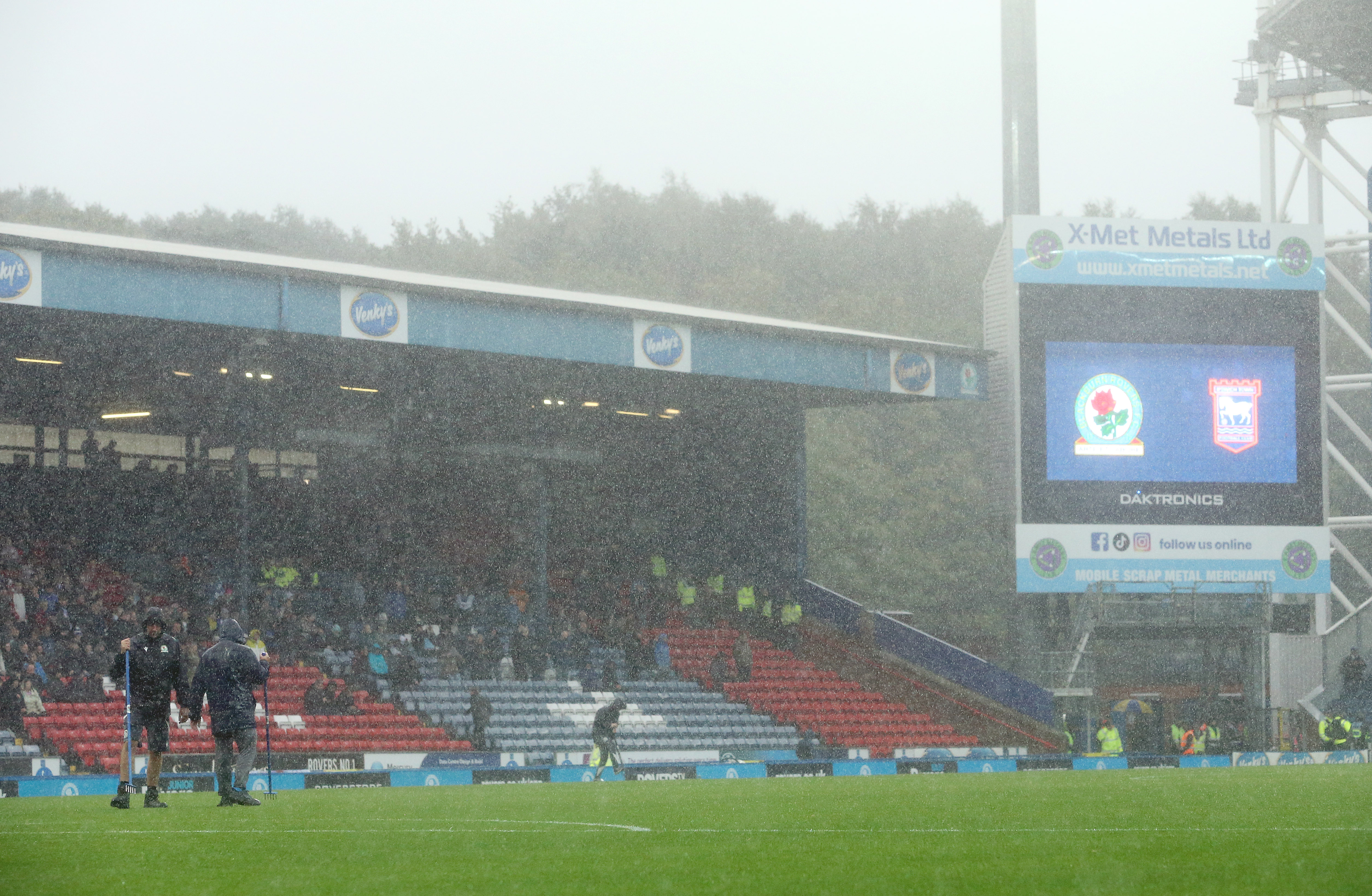 BLACKBURN, ENGLAND - SEPTEMBER 20: Heavy rain falls as groundsmen attempt to release water from the waterlogged pitch at Ewood Park as play is suspended due to heavy rain during the Sky Bet Championship match between Blackburn Rovers and Ipswich Town at Ewood Park on September 20, 2025 in Blackburn, England. (Photo by Rich Linley - CameraSport via Getty Images)