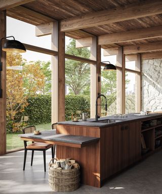 Kitchen with stone floors and wooden island and floor to ceiling glass windows