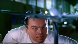 Leonardo DiCaprio gazes up at an airplane model in The Aviator.