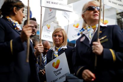 Ex-Thomas Cook employees demonstrate in London on October 2, 2019, after delivering a petition calling for a full inquiry into Thomas Cook's collapse and for the company's directors to pay ba