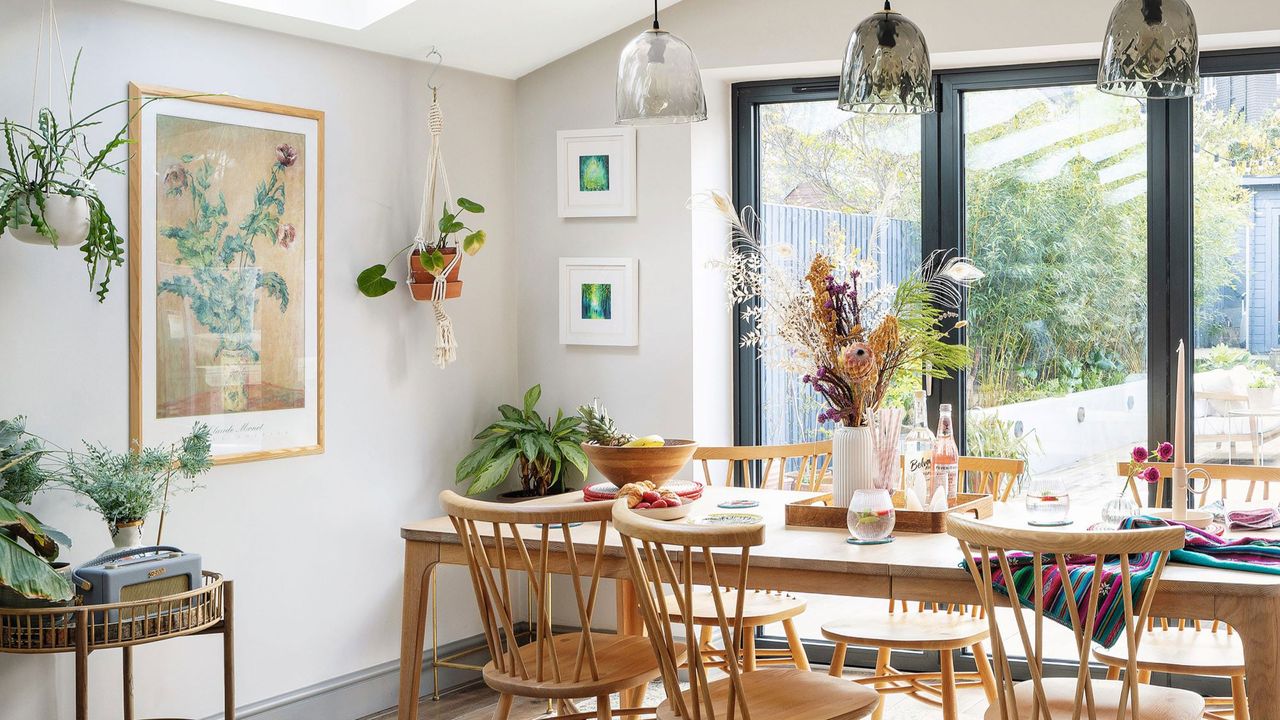 White house with wooden table and houseplants