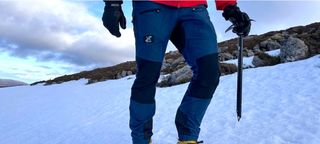 Man wearing Revolution Race Nordwand Pro hiking pants in snow