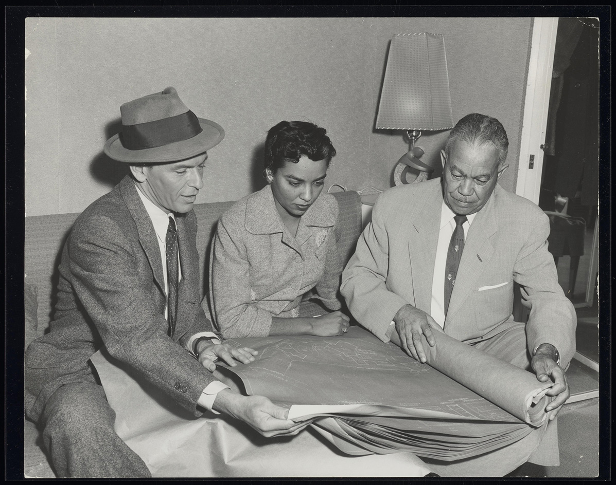 Frank Sinatra, Norma Harvey and Paul R, Williams reviewing plans, 1956