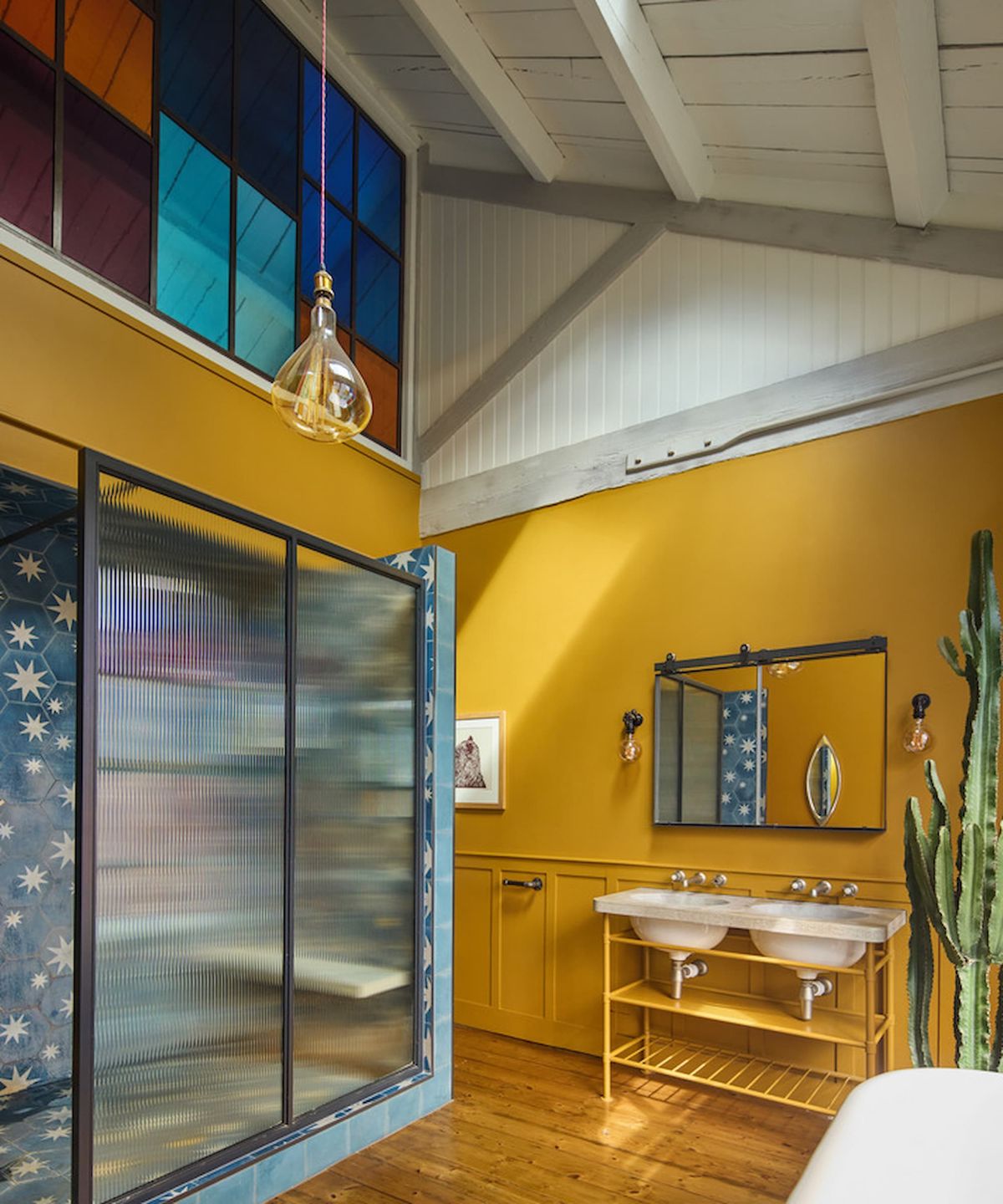 A bathroom with a vaulted ceiling and stained glass windows inside and a walk in shower