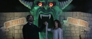 Dr. Mortis and wife in front of Dr. Mortis' House of Horrors home haunt in V/H/S/Halloween