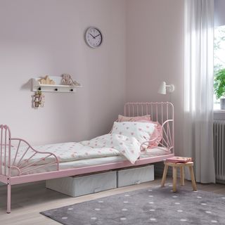 Pink bed frame with heart-patterned bedding