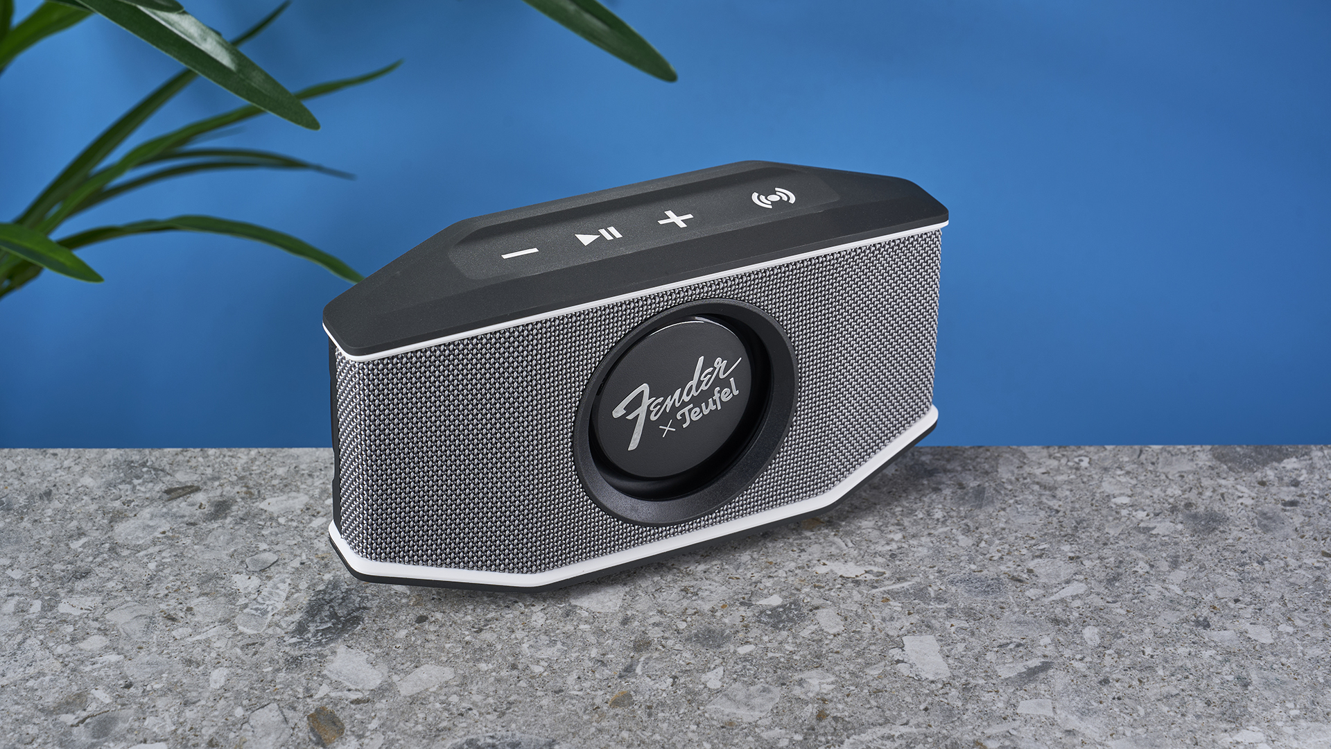 a retro-inspired bluetooth speaker 8 inches long and 4 inches tall with a circular woofer in the center branded with Fender and Teufel