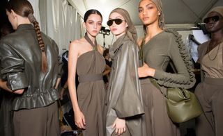 Models wear khaki dress, jacket and top with scarves