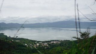 Widok z bujnej dżungli z widokiem na jezioro Bosumtwi, które zostało stworzone przez krater uderzenia