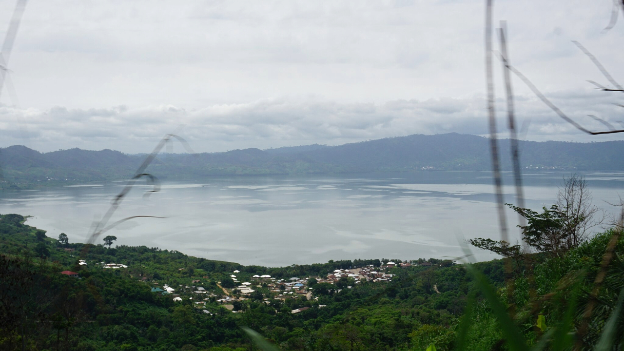 A view from a lush jungle overlooking the Bosumtwi lake which was created by an impact crater