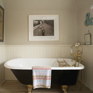 bathroom with bathtub and wall picture
