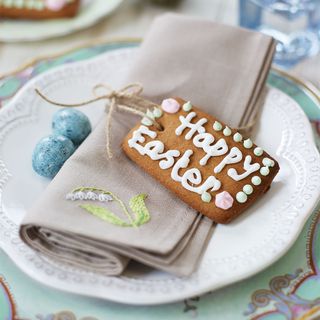 Happy Easter decorated biscuit on plate with napkin