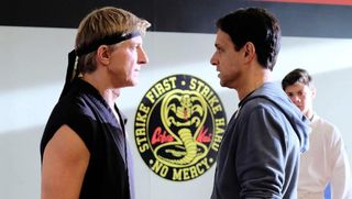 A movie still of two Cobra Kai characters facing off