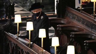 Queen Elizabeth II watches as pallbearers carry the coffin of Prince Philip, Duke Of Edinburgh into St George’s Chapel